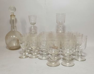 a lot of wine glasses and a decanter on the table