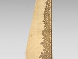 a gold and white table runner with a floral design on it