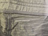 the back of a pair of gray pants with a white logo on it