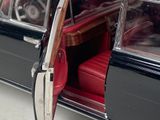 a black car with a red seat in the back of it