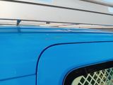 a blue van parked on the side of the road