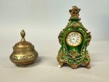 a small green and gold clock sitting next to a smaller gold and green clock