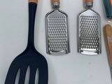 several kitchen utensils are lined up on a counter top