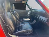 a red car with black leather seats in the back of it