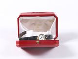 a red box with a watch in it on a white surface