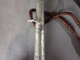 a silver metal object with a rope on top of it