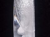 a glass vase with ice in it sitting on a table