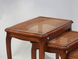 three wooden tables with wicker tops on a white background