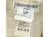 the label on the back of a white jacket is attached to a white shirt