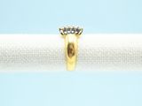 a close up of a gold ring on a white cloth