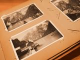 an open book with pictures of a lake and mountains on it
