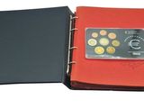 an image of a red binder with a credit card inside of it