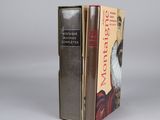 two books are stacked on top of each other on a table
