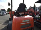 a small tractor that is parked in the parking lot
