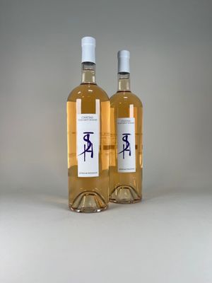 two bottles of wine sitting next to each other on a table
