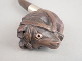 a picture of a wooden pipe holder with a horse head on it