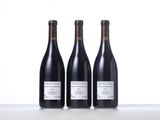 three bottles of wine sitting on top of a table next to each other
