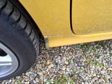a yellow car that is parked on the side of the road