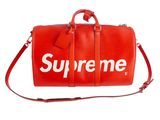 a red supreme duffel bag on a white background