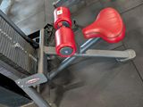 a red fire extinguisher sitting on the floor next to a metal pole