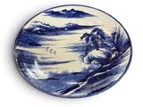 a blue and white plate with a picture of a man riding a horse