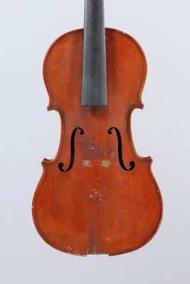 an old violin with a bow hanging from it ' s back