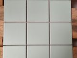 a picture of a square mirror on a wooden table