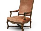 an old chair with a brown upholstered seat and a brown upholstered seat