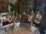 three candles that are sitting on a table in a room