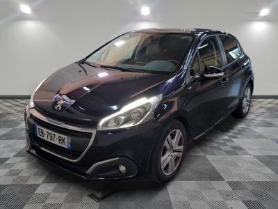 the small black car is parked in a large room