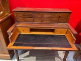 a wooden desk with a drawer on top of it