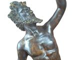 bronze statue of a man reaching up to catch a frisbee