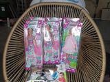 a wicker chair with a lot of barbie dolls in it