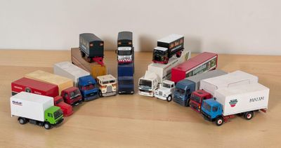 Plusieurs camions miniatures sont alignés en cercle sur une table en bois
