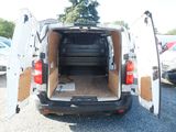 a white van with its doors open in a parking lot
