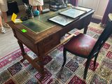 a desk with a chair and a book on it