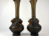 two vases sitting side by side on a white surface