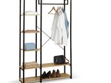 a wooden rack with clothes hanging on it and a pair of shoes