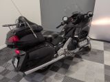 a black motorcycle parked in a room with a checkered floor
