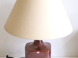 a lamp that is sitting on a table next to a lamp shade
