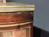 a glass display case with a clock on top of it