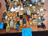 many bottles of perfume on a table with a price tag