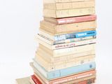many books stacked on top of each other on a table