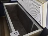 a large open refrigerator sitting on a wooden floor in a room