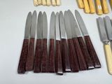 many different types of knives and knives on the table