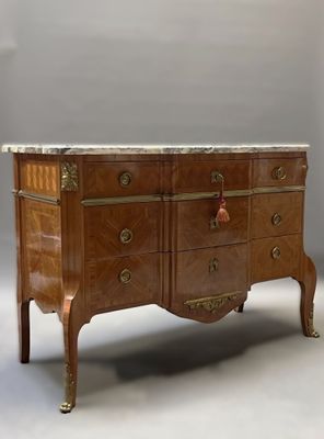 a marble top chest of drawers on a stand