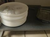 a stack of plates and pans sitting on a shelf