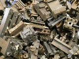 a pile of old metal parts sitting on top of a table
