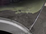 a close up of a car ' s paint on the side of the road
