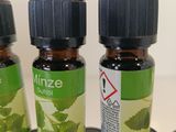 several bottles of essential oils are lined up on a table